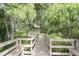 Inviting gazebo on a lush green lawn, accessible via a wooden walkway with benches at 11503 Robles Del Rio Pl, Temple Terrace, FL 33617