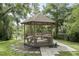 Beautiful gazebo with seating overlooking the pond at 11503 Robles Del Rio Pl, Temple Terrace, FL 33617