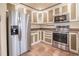 Modern kitchen with stainless steel appliances and two-tone cabinets for ample storage space at 11503 Robles Del Rio Pl, Temple Terrace, FL 33617
