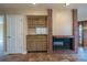 Cozy living room featuring a fireplace, wood cabinets with sink, and access to another room at 11503 Robles Del Rio Pl, Temple Terrace, FL 33617
