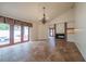 Bright living room with tile floors, a fireplace, chandelier, and French doors to the outdoor courtyard at 11503 Robles Del Rio Pl, Temple Terrace, FL 33617