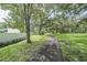 Scenic view of a walkway winding through a community park with mature trees at 11503 Robles Del Rio Pl, Temple Terrace, FL 33617