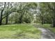 Scenic view of a walkway winding through a community park with mature trees and gazebo at 11503 Robles Del Rio Pl, Temple Terrace, FL 33617