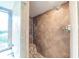 Walk-in shower featuring tile, a rain shower head, and a built-in bench at 11503 Robles Del Rio Pl, Temple Terrace, FL 33617
