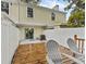 Outdoor deck with chairs and a partially fenced yard at 12336 Villager Ct, Tampa, FL 33625