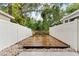Private backyard area with wood deck and stone area at 12336 Villager Ct, Tampa, FL 33625