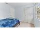 Bright bedroom with a double door closet and a large window at 12336 Villager Ct, Tampa, FL 33625