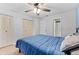 Cozy bedroom with a ceiling fan and double door closet at 12336 Villager Ct, Tampa, FL 33625