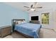 Comfortable bedroom featuring a ceiling fan and a large window for natural light at 12336 Villager Ct, Tampa, FL 33625