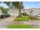 Charming townhome with a well-manicured lawn, front garden bed, and a private driveway at 12336 Villager Ct, Tampa, FL 33625