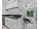 Kitchen with granite countertops, modern cabinetry, and an open view into the living area at 12336 Villager Ct, Tampa, FL 33625