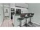 Modern kitchen featuring a breakfast bar with stools and contemporary appliances at 12336 Villager Ct, Tampa, FL 33625
