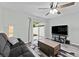 Cozy living room with a comfortable sofa, sliding glass door, and modern entertainment setup at 12336 Villager Ct, Tampa, FL 33625
