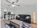 Comfortable living room with modern furnishings, a ceiling fan, and an open view into the kitchen at 12336 Villager Ct, Tampa, FL 33625