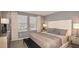 Stylish bedroom with neutral tones, large windows, and a comfortable bed with decorative pillows at 13236 Stable Pl, Parrish, FL 34219