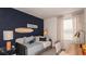 Cozy bedroom decorated with a beach theme, featuring a daybed and a surf board wall decor at 13236 Stable Pl, Parrish, FL 34219