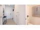 Entryway featuring light tile flooring, a white front door, half bath, and staircase at 13236 Stable Pl, Parrish, FL 34219