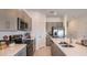 Modern kitchen features stainless steel appliances, grey cabinets, and a sink with a large faucet at 13236 Stable Pl, Parrish, FL 34219