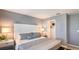 Contemporary bedroom with gray walls, carpet flooring, upholstered headboard, and walk-in closet at 13236 Stable Pl, Parrish, FL 34219