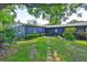 View of house from the expansive backyard with pavers leading to back door at 1708 Pond Lake Dr, Tampa, FL 33612