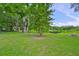 Large backyard with mature trees and view of the lake, perfect for outdoor activities at 1708 Pond Lake Dr, Tampa, FL 33612