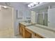 Bathroom featuring a vanity with storage, a large mirror, and a walk-in shower at 1708 Pond Lake Dr, Tampa, FL 33612