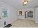 Open bonus room with tile floors, a breakfast bar to the kitchen, and seamless transitions to the backyard at 1708 Pond Lake Dr, Tampa, FL 33612