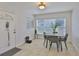 Charming dining area features tile floors, a dining table, and a front door with a window at 1708 Pond Lake Dr, Tampa, FL 33612