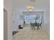 Bright dining area with neutral tile, a modern table setting, and ample natural light from a large window at 1708 Pond Lake Dr, Tampa, FL 33612