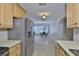 Bright kitchen transitions into the dining area, featuring stainless steel appliances and wooden cabinets at 1708 Pond Lake Dr, Tampa, FL 33612