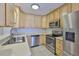 Modern kitchen with stainless steel appliances, stylish cabinets, and smooth countertops for culinary enthusiasts at 1708 Pond Lake Dr, Tampa, FL 33612
