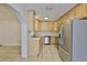 Well-appointed kitchen features stainless steel appliances, sleek countertops, and bright wooden cabinetry at 1708 Pond Lake Dr, Tampa, FL 33612