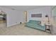 Open living room layout featuring tile floors, natural light, and a loveseat at 1708 Pond Lake Dr, Tampa, FL 33612
