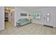 Cozy living room with tile flooring, a loveseat, and bright natural light at 1708 Pond Lake Dr, Tampa, FL 33612