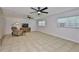 Spacious living room featuring tile floors, two ceiling fans, and natural light at 1708 Pond Lake Dr, Tampa, FL 33612