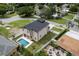 An aerial view of a property that includes a swimming pool, a covered patio, and a fenced yard at 1808 W Erna Dr, Tampa, FL 33603