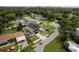 Wide aerial view of modern home with meticulous landscaping, driveway, and fenced perimeter at 1808 W Erna Dr, Tampa, FL 33603