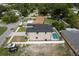 Aerial view of the home and yard, including a pool and view of the surrounding neighborhood at 1808 W Erna Dr, Tampa, FL 33603