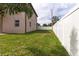 Spacious backyard enclosed by a white fence, offering privacy and a well-maintained lawn at 1808 W Erna Dr, Tampa, FL 33603