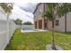 Backyard boasts a modern pool and manicured landscaping, framed by a pristine white fence at 1808 W Erna Dr, Tampa, FL 33603