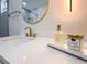 Close up on modern white bathroom vanity with quartz countertop, and gold fixtures at 1808 W Erna Dr, Tampa, FL 33603