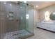 Spacious bathroom featuring a glass shower with designer tile, double vanity and modern lighting at 1808 W Erna Dr, Tampa, FL 33603