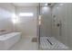 Bathroom featuring a soaking tub, glass enclosed shower with designer tile, and brushed gold hardware at 1808 W Erna Dr, Tampa, FL 33603