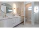 Elegant bathroom with double vanity, modern lighting, and a separate toilet room at 1808 W Erna Dr, Tampa, FL 33603