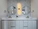 Modern bathroom with double vanity, quartz countertop, and decorative light fixture at 1808 W Erna Dr, Tampa, FL 33603