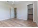 Bedroom showcasing beautiful hardwood floors, open doorway, and walk-in closet at 1808 W Erna Dr, Tampa, FL 33603