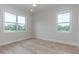 Bright bedroom with two windows and light hardwood floors at 1808 W Erna Dr, Tampa, FL 33603