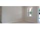 Bright bedroom with tile floor, window overlooking the pool area, and an open doorway at 1808 W Erna Dr, Tampa, FL 33603