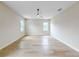 A bright bedroom featuring hardwood floors, a ceiling fan, and natural light from two windows at 1808 W Erna Dr, Tampa, FL 33603