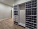Walk-in closet boasts custom shelving, drawers, shoe rack and bronze hardware at 1808 W Erna Dr, Tampa, FL 33603